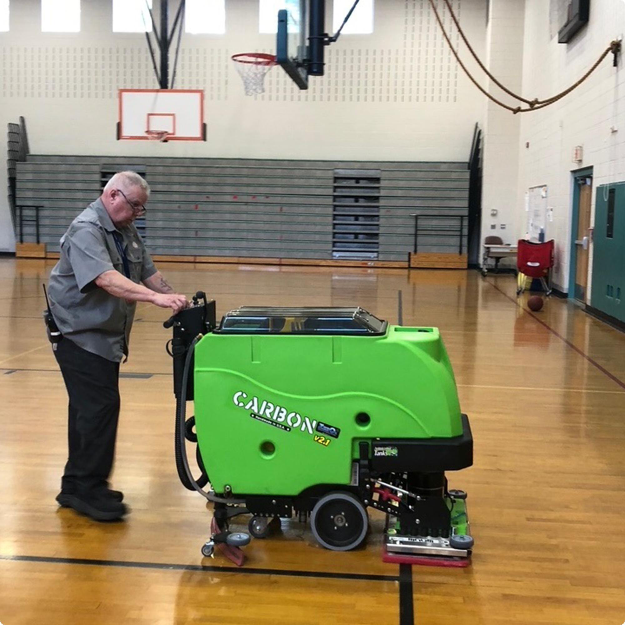 Tomcat Carbon 28" EDGE walk behind  floor scubber with anti-microbial tank option cleaning a wood floor in a gymnasium IMG0001