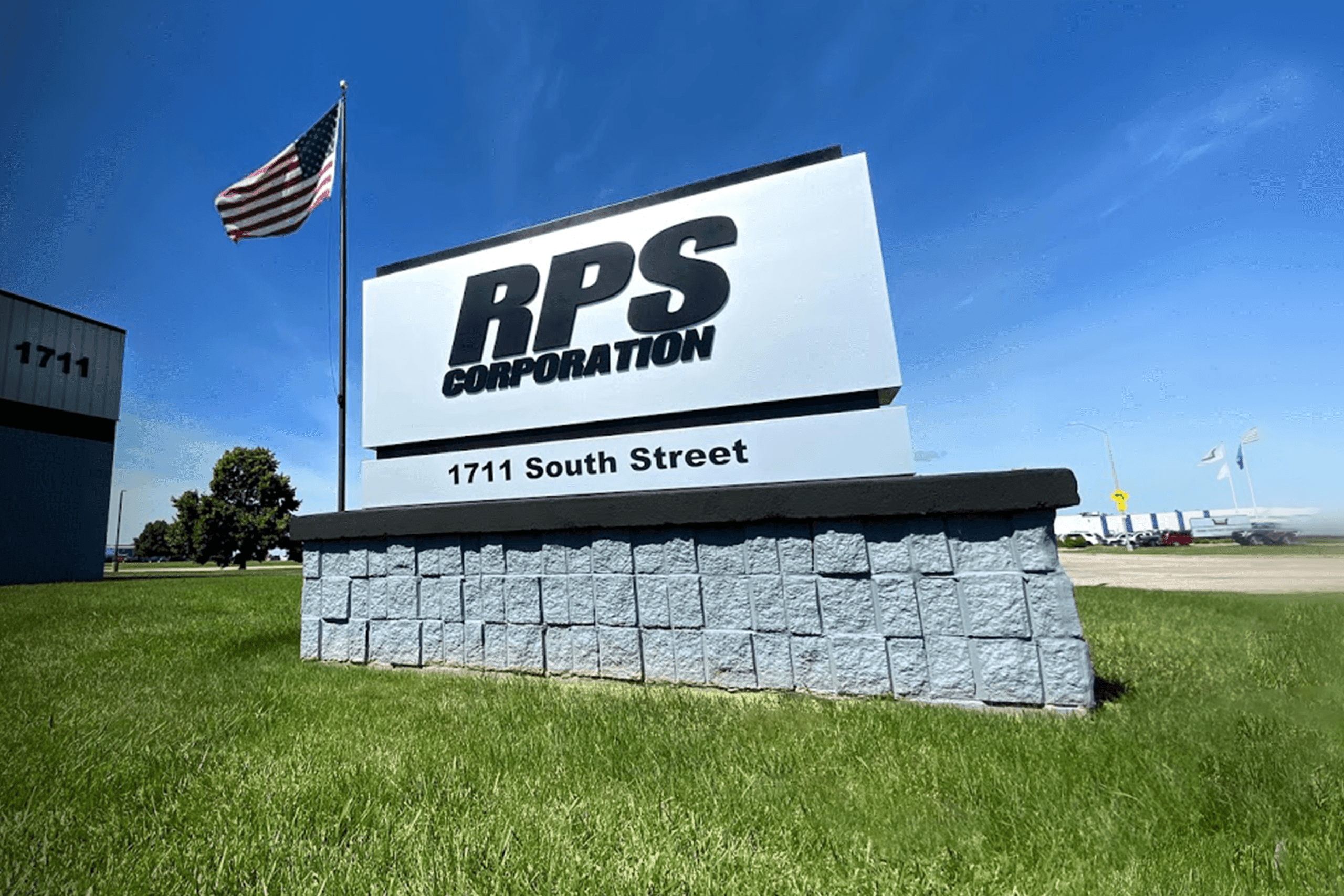 Tomcat corporate signage showcasing the american flag and the parent company, RPS Corporation