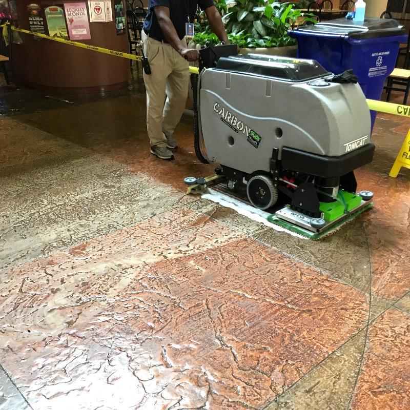 Tomcat Walk Behind Floor Scrubbers Carbon lobby epoxy CARBON Walk Behind Floor Scrubber cleans the epoxy coated stamped concrete in a Las Vegas Casino