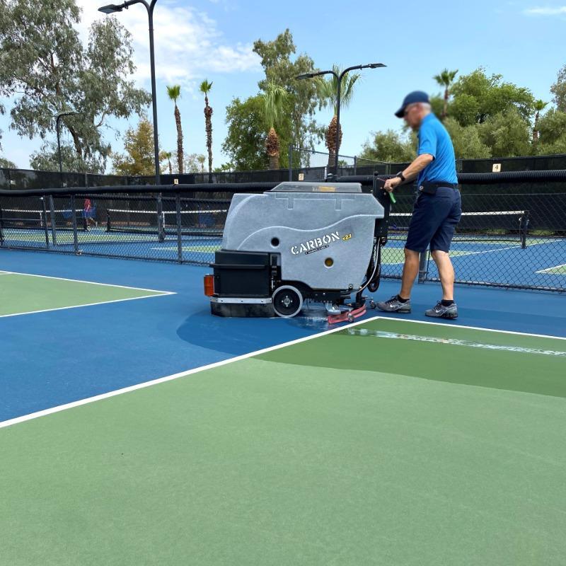 Tomcat Walk Behind Floor Scrubbers Carbon tennis court concrete CARBON Walk Behind Floor Scrubber cleaning the tennis courts at a Dayton, Ohio health club.