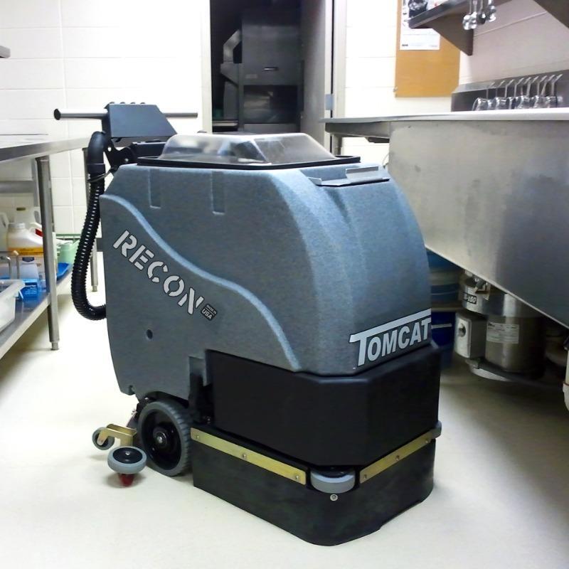 Tomcat Walk Behind Floor Scrubbers Recon kitchens epoxy RECON battery Walk Behind Floor Scrubber cleans the floor of a commercial kitchen in an Orlando, Florida Amusement Park