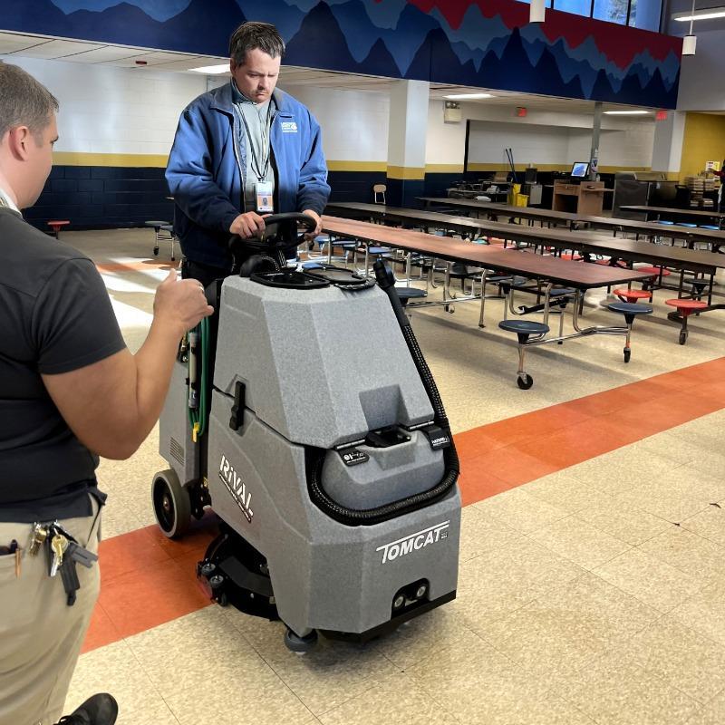 Tomcat Stand On Floor Scrubbers Rival cafeteria vct A Tomcat Rival stand on battery floor scrubber cleaning the VCT floor of a Middle School cafeteria in Naperville, IL