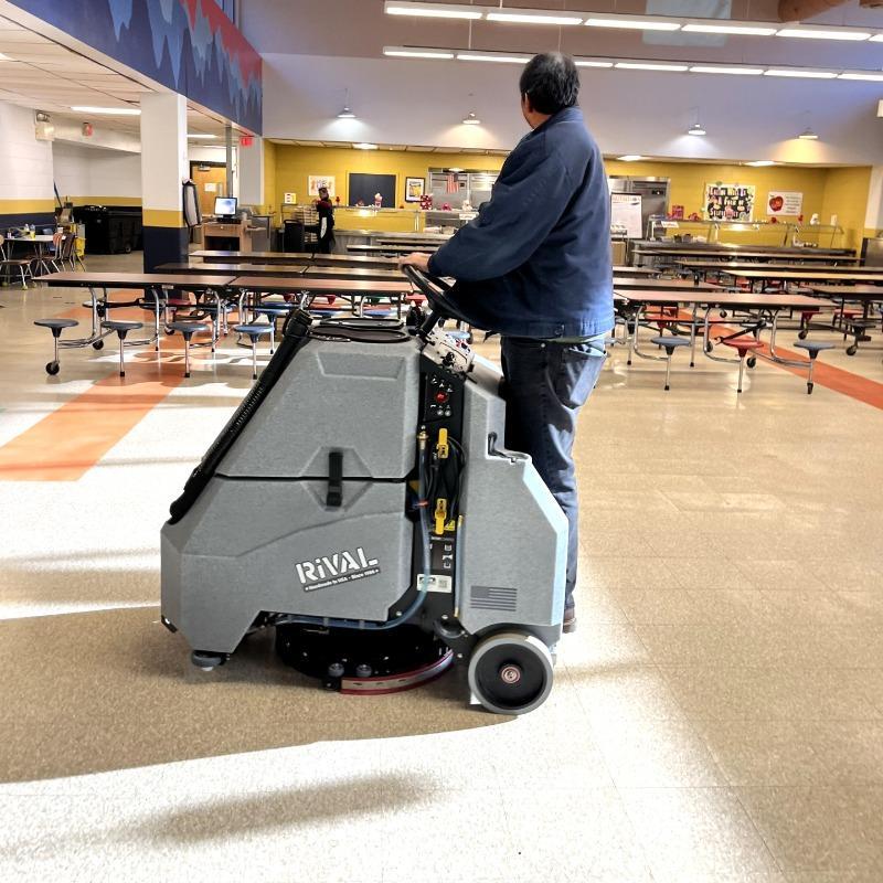 Tomcat Stand On Floor Scrubbers Rival cafeteria vct A Tomcat Rival stand on battery floor scrubber cleaning the VCT floor of a Middle School cafeteria in Naperville, IL