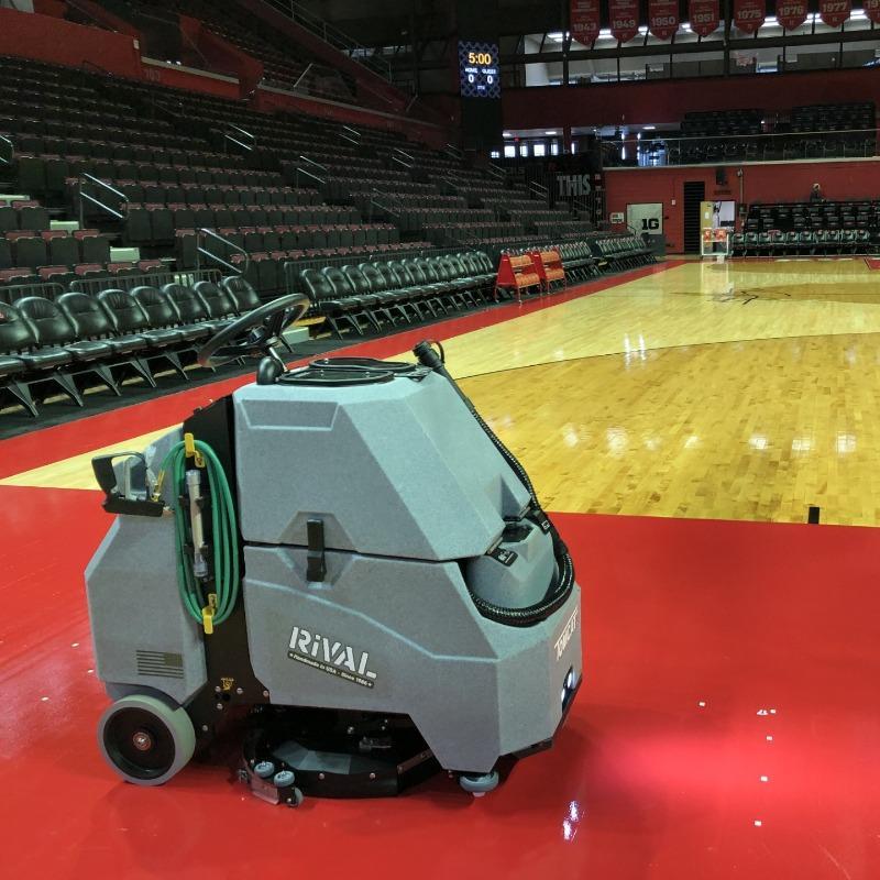 Tomcat Stand On Floor Scrubbers Rival courts gym floors A Tomcat Rival Stand On floor scrubber cleans the wood floor on a basketball court in a university arena in Delaware.