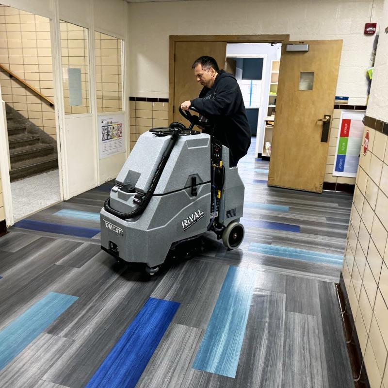 Tomcat Stand On Floor Scrubbers Rival halls vinyl floors A Tomcat Rival stand on battery floor scrubber cleaning the vinyl floor of a hall at a university in Lexington, KY