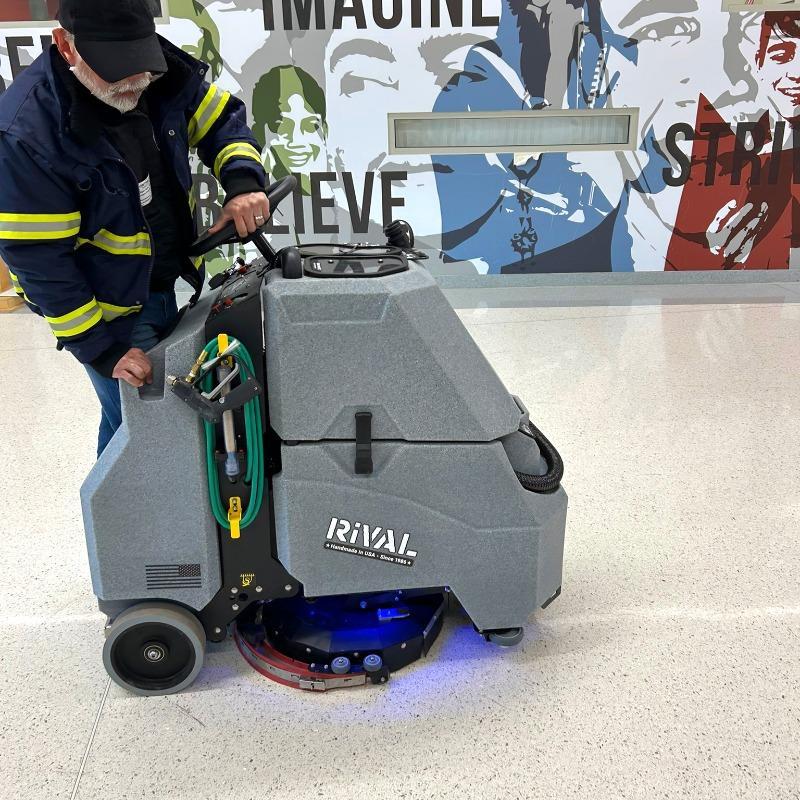 Tomcat Stand On Floor Scrubbers Rival hallways terrazzo A Tomcat Rival stand on battery floor scrubber cleaning the terrazzo floor of a hallway in Norfolk, VA