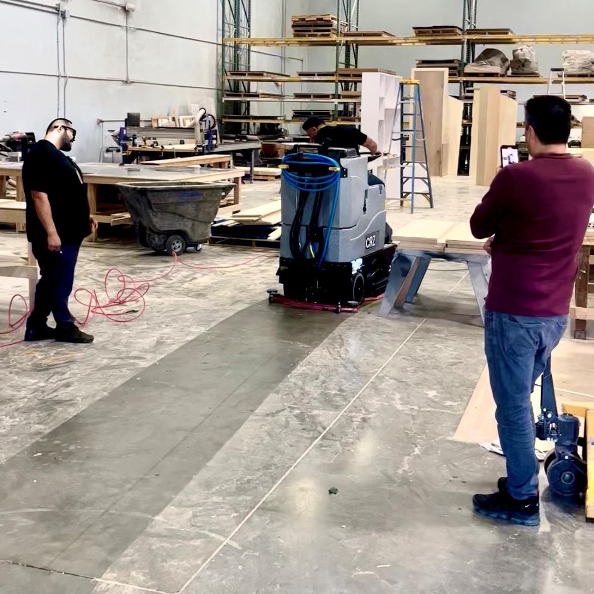 Tomcat Ride On Floor Scrubbers CRZ production floor concrete A Tomcat CRZ ride on auto scrubber cleans the production area of a display manufacturer in California.