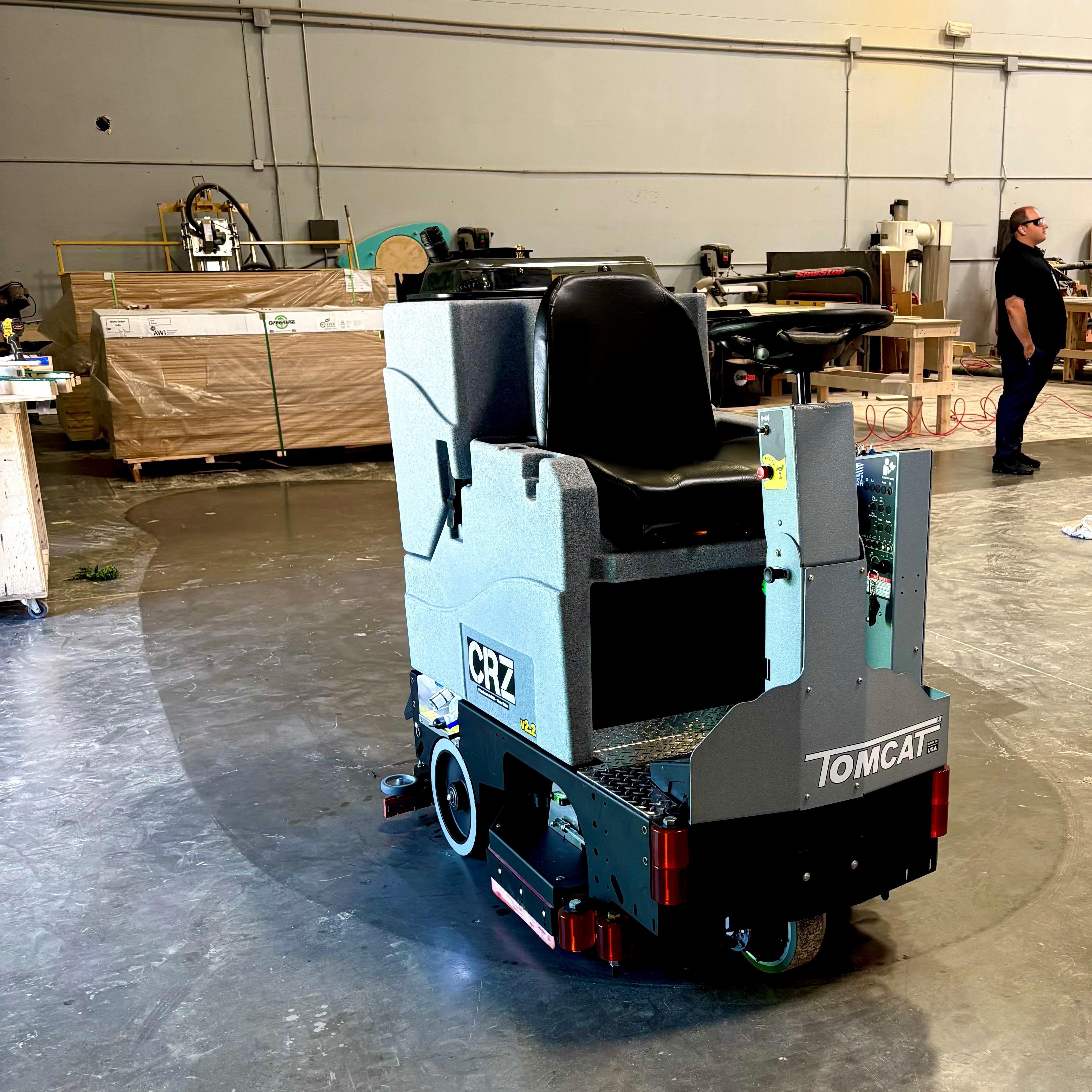 Tomcat Ride On Floor Scrubbers CRZ production floor concrete A Tomcat CRZ ride on auto scrubber cleans the production area of a display manufacturer in California.