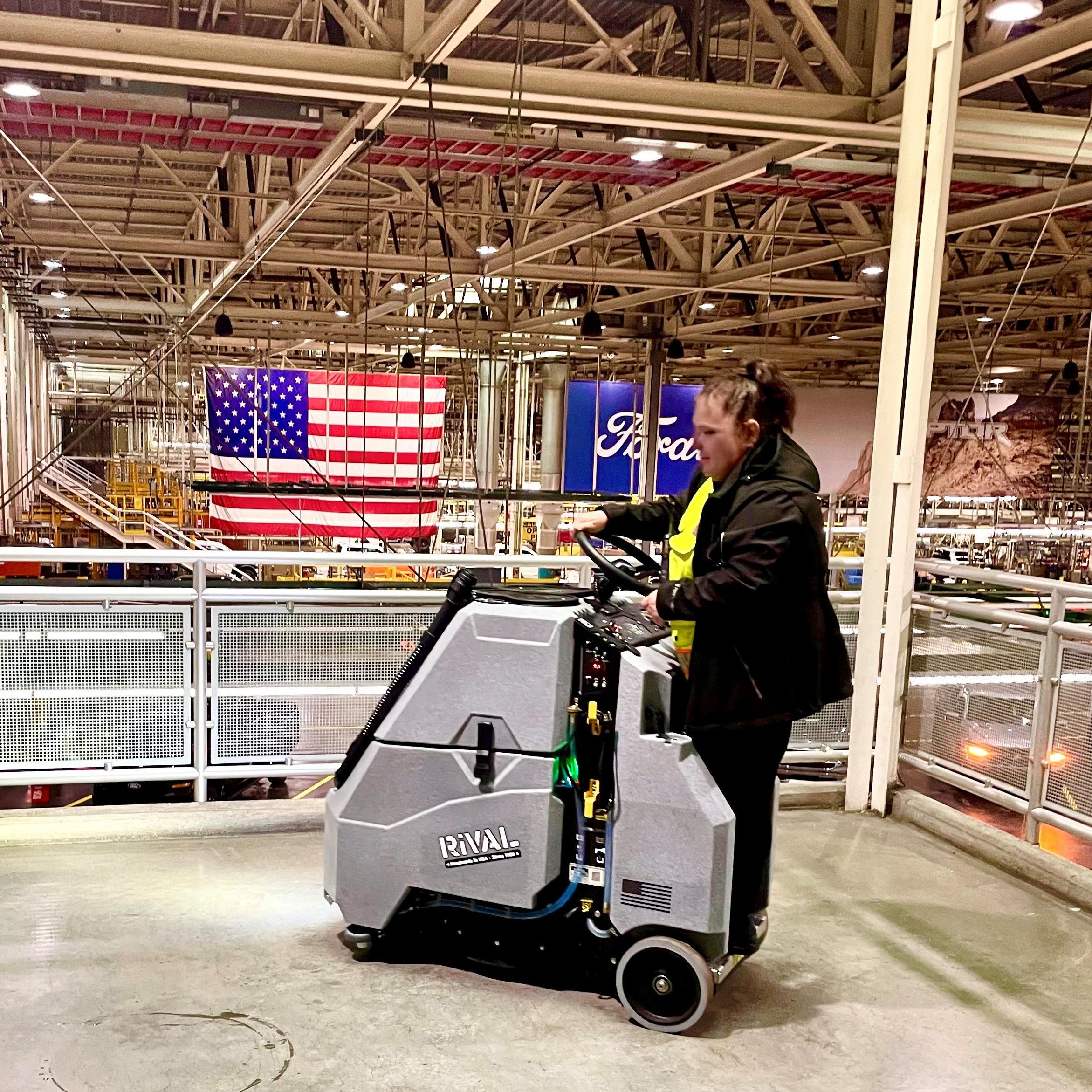 Tomcat Stand On Floor Scrubbers Rival manufacturing floors concrete Cleaning the concrete floor on a mezzanine in an auto manufacturing facility with a Tomcat Rival stand on floor scrubber.